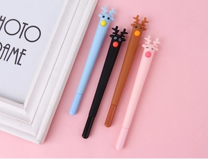 Close-up of four colorful cartoon deer gel pens on a soft pink background for stationery