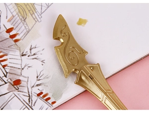 Close-up of golden sword pen with cloud patterns on a notebook with landscape art
