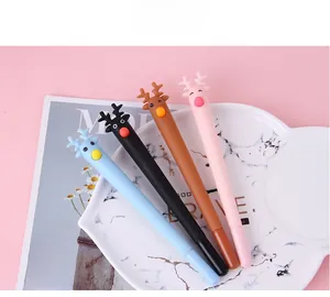 Close-up of four colorful cartoon reindeer pens on a stylish marble aesthetic tray