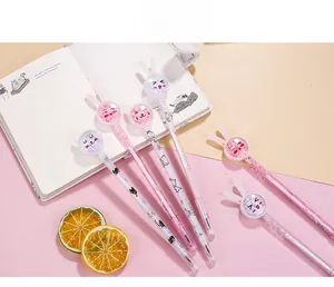 Detail of bunny ear gel pens with glitter filled tops and cute cat prints on paper