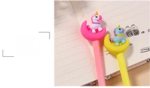 Detail of cute cartoon unicorn sitting on moon-shaped pen caps in pink and yellow