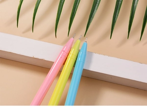 Close-up of pastel unicorn pens with needle-point tips on a minimalist desk setting