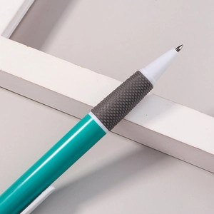 Teal retractable ballpoint pen with grey ergonomic non-slip grip on grey background