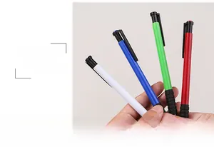 Close-up of four colorful retractable ballpoint pens with black non-slip rubber grips