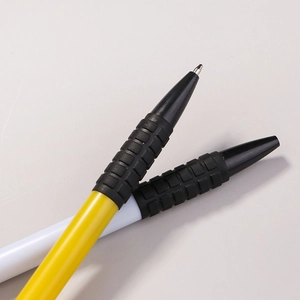 Classic click ballpoint pens with yellow and white barrels and black textured rubber grips