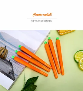 Detail of cute carrot gel pens with orange barrels and green silicone leaf tops on a desk
