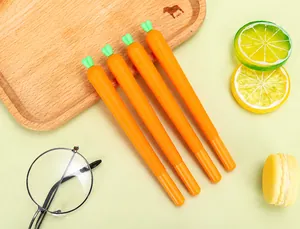 Close-up of four cute carrot-shaped gel pens set on a decorative wooden tray with props