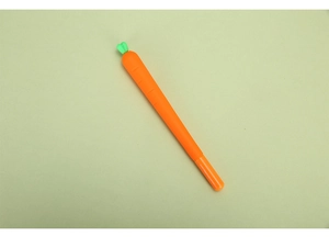 Macro shot of creative carrot-shaped gel pen with realistic textures on green background