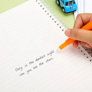 Cute carrot-shaped orange gel pen writing smooth black ink on a white spiral notebook