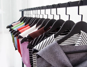 Close-up of assorted colorful knitted shoulder shawls hanging on a metal rack