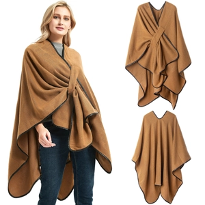 Women's camel knit poncho featuring faux leather trim and asymmetrical crossover design