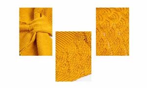 Macro view of mustard yellow knit shawl featuring cable stitch and hollow wave textures