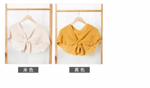 Detail view of knitted faux collars with twisted pattern in beige and yellow shades