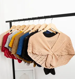 Knitted hollow shawl collection featuring crisscross twist design in various colors on hangers