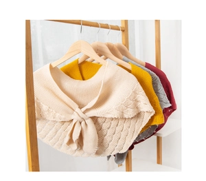 Detailed knit pattern on hollowed-out shawls with scalloped edges and tie closure
