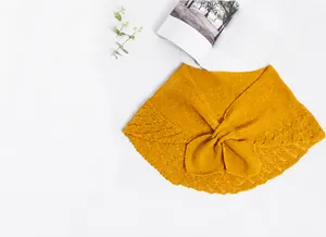 Macro detail of bright yellow knitted shawl featuring hollow lace edges and ribbed texture