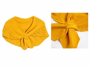 Close-up of ginger yellow knitted hollow shawl featuring delicate wave patterns and cross collar