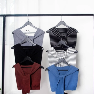 Variety of knitted false collar scarves in solid colors and stripes on hangers