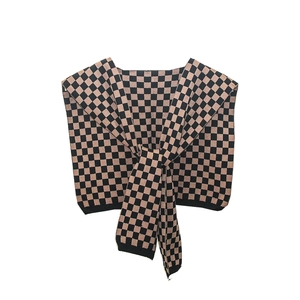 Women's knitted checkerboard shawl in brown and black with front tie knot detail