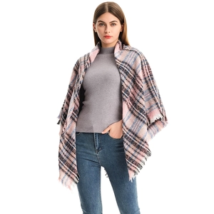 Close-up of thick plaid scarf featuring soft textured knit and long tassel fringe details