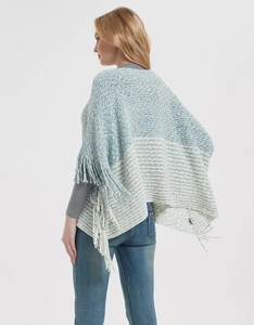 Detail view of teal striped knitted poncho with long tassels and intricate cable pattern