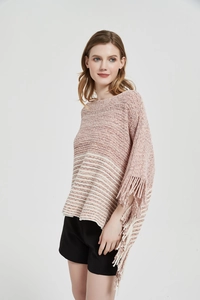 Detail shot of pink and white knit poncho showing fringe edges and striped texture