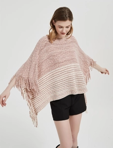 Close-up of pink and white striped knit poncho sweater featuring long fringe tassels