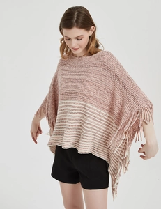Detail shot of pink and white striped knit poncho with elegant fringe hem and soft texture
