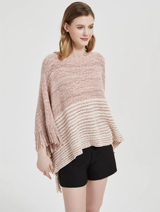 Detail of soft knit tassel poncho featuring pink stripes and decorative fringe hemline
