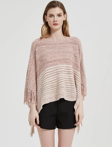 Detail of pink and white striped knit poncho featuring long fringe trim and soft texture