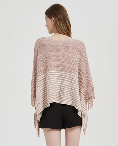 Detail of pink and white striped knit poncho showing the fringed hem and textured fabric