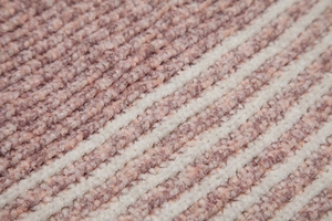 Macro view of ribbed knit fabric texture in dusty rose and cream white stripes