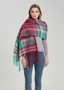 Macro detail of plaid scarf with thick tassels in fuchsia, green and white knit