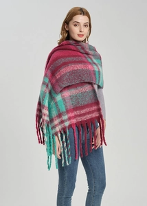 Close-up of thick checkered scarf featuring long tassels and burgundy plaid texture