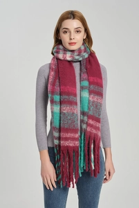 Close-up of thick plaid mohair scarf with vibrant burgundy teal checks and long tassels