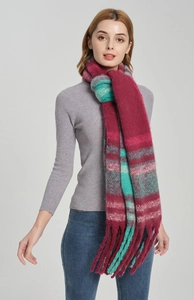 Detail of soft mohair-like plaid scarf with thick fringe in red and green colors