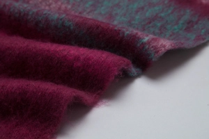 Detail of soft mohair-like fuchsia and teal plaid scarf with rich fuzzy texture