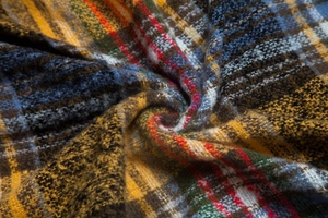 Detailed macro view of the thick checkered wool texture and woven pattern on the shawl