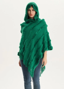 Detail of emerald green hooded knit poncho with faux fur trim and fringe tassels