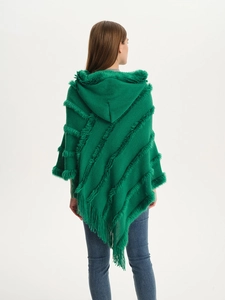 Detail view of emerald green knit poncho with soft plush stripes and fringe tassels