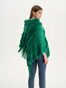 Detail view of dark green hooded knit poncho with tassel fringe and textured stripes
