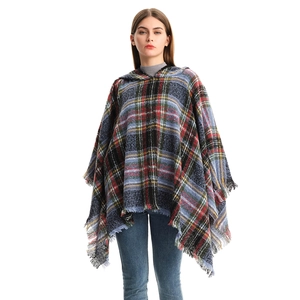 Women's plaid hooded poncho with tassels in vibrant red and blue checked pattern