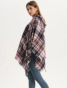 Close-up of red, white, and blue plaid poncho featuring soft fringe trim and a cozy hood
