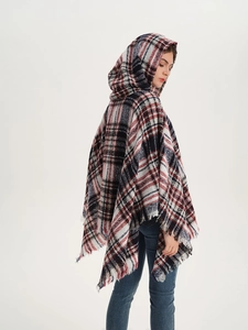 Detailed back view of a plaid hooded poncho with soft fringe edges and fabric texture