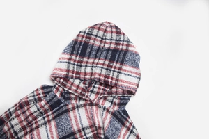 Close-up of the hooded neckline on a thick red, white, and blue checkered knit poncho