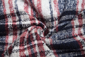 Macro shot of red, white, and dark blue plaid knitted fabric with a soft textured finish