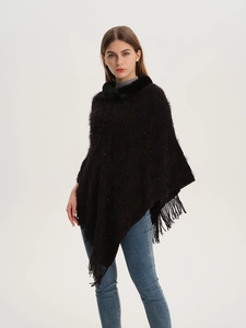 Detail of sequined knit poncho featuring a faux fur collar and fringed hem in dark brown