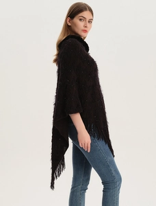 Detail of dark brown faux fur collar knit poncho with sequin accents and fringed hemline