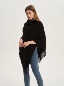 Detail of black knit shawl featuring a faux fur collar and elegant fringe hem tassels