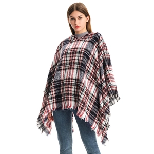 Women's plaid hooded poncho cape with tassel trim in classic red, black, and white pattern